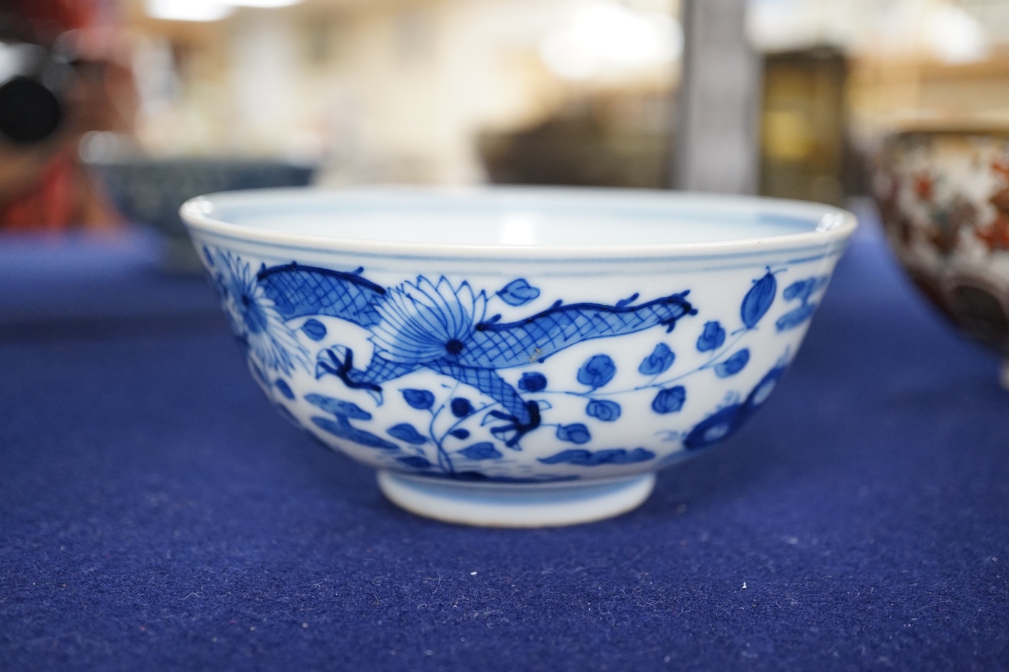 A Chinese blue and white ‘dragon’ bowl, Qianlong mark but 19th century, 12.5cm diameter. Condition - overglazed imperfection